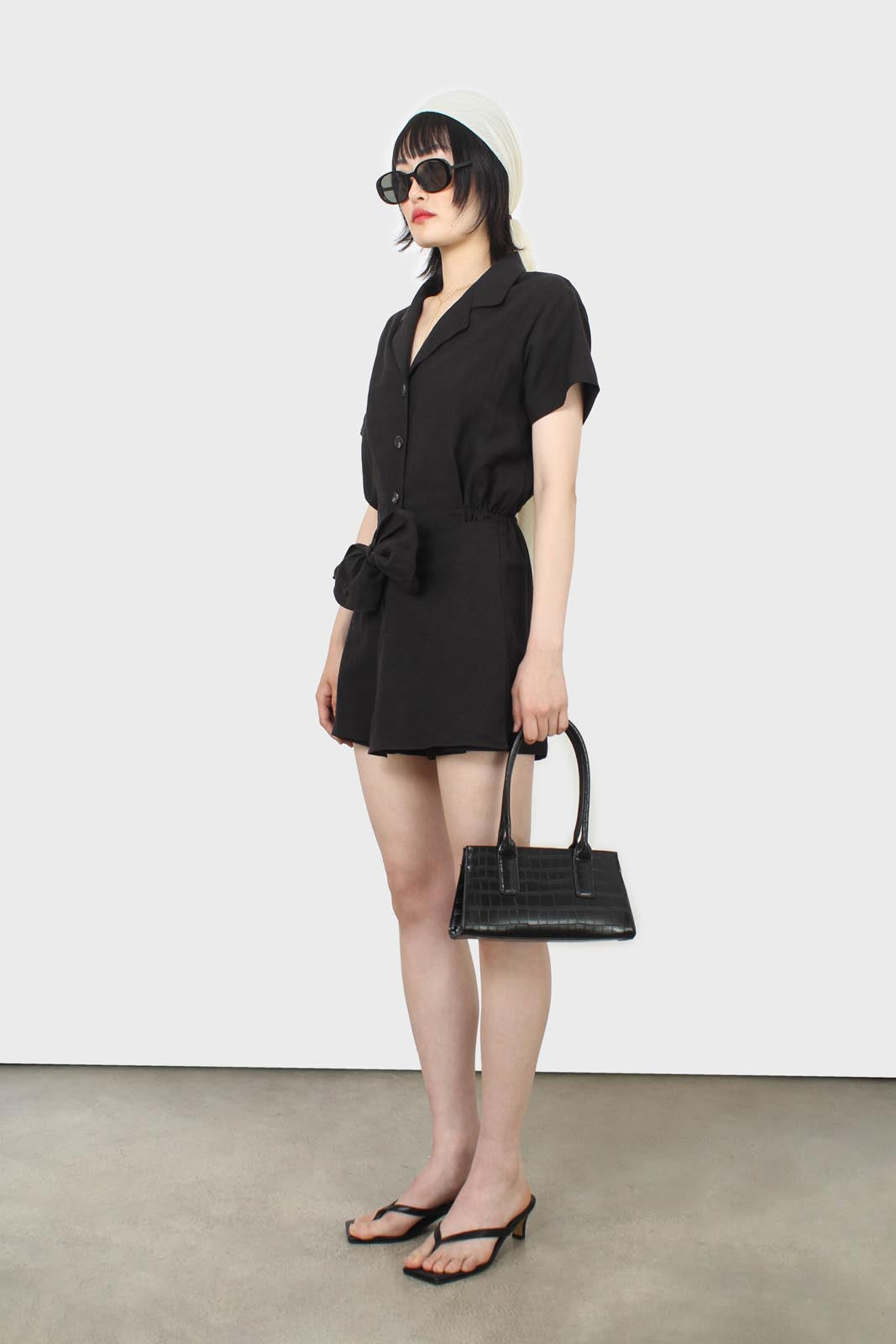 Black short sleeved button up tie waist romper_9