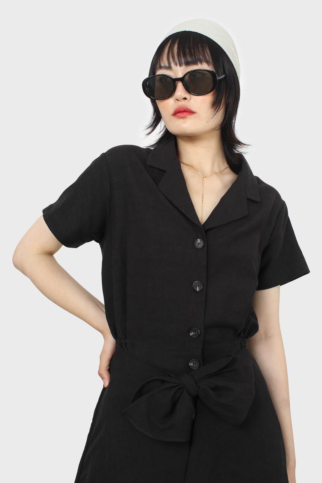 Black short sleeved button up tie waist romper_11