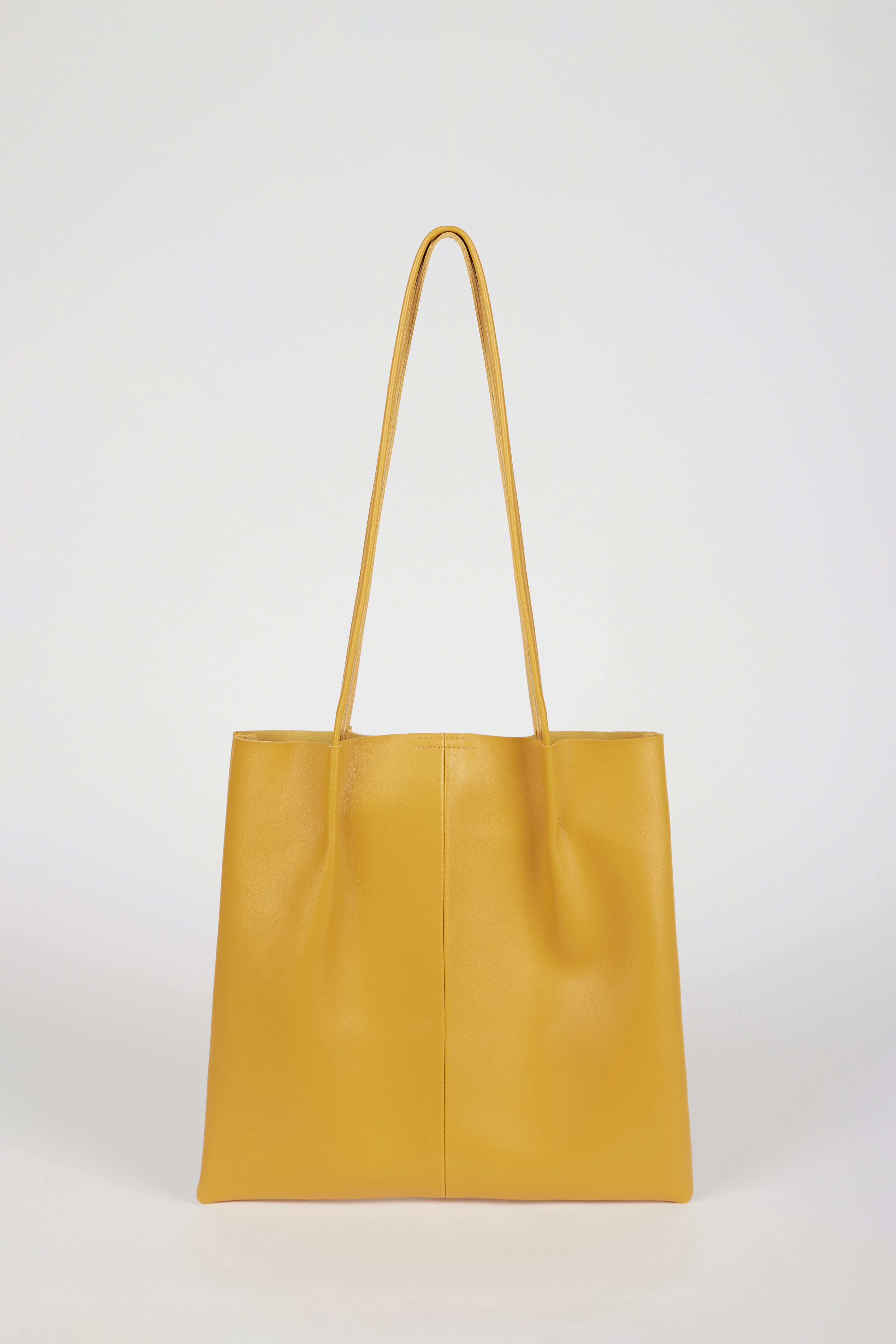 Mustard vegan leather pinched strap tote bag_1