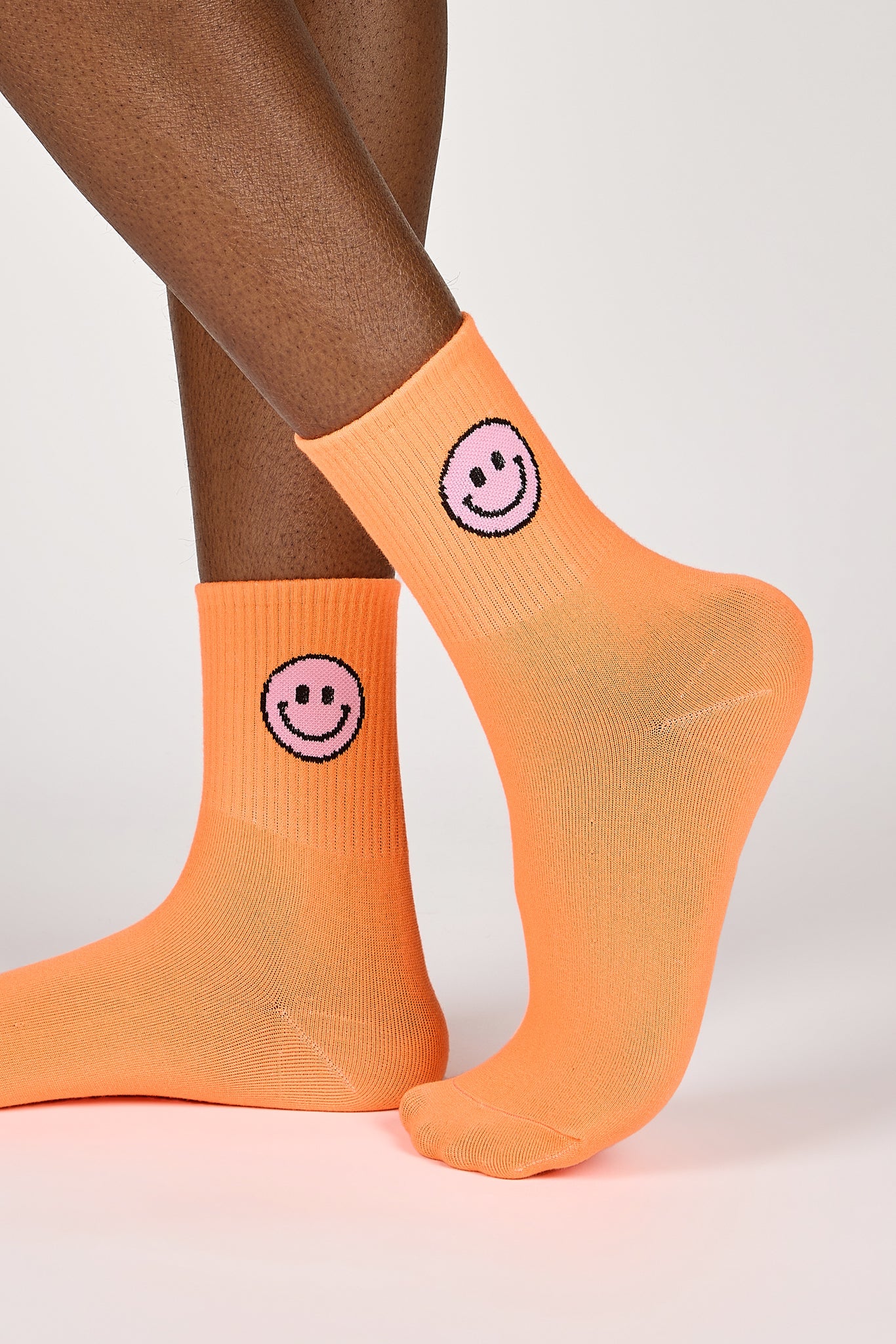 Neon orange smiley face socks_1