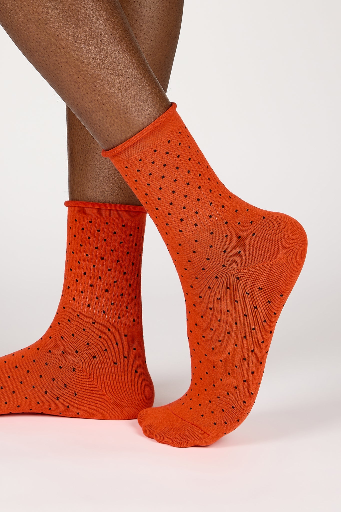 Red-orange and black polka dot roll trim socks_1