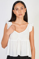 Ivory ruffle trim tie back tank_1
