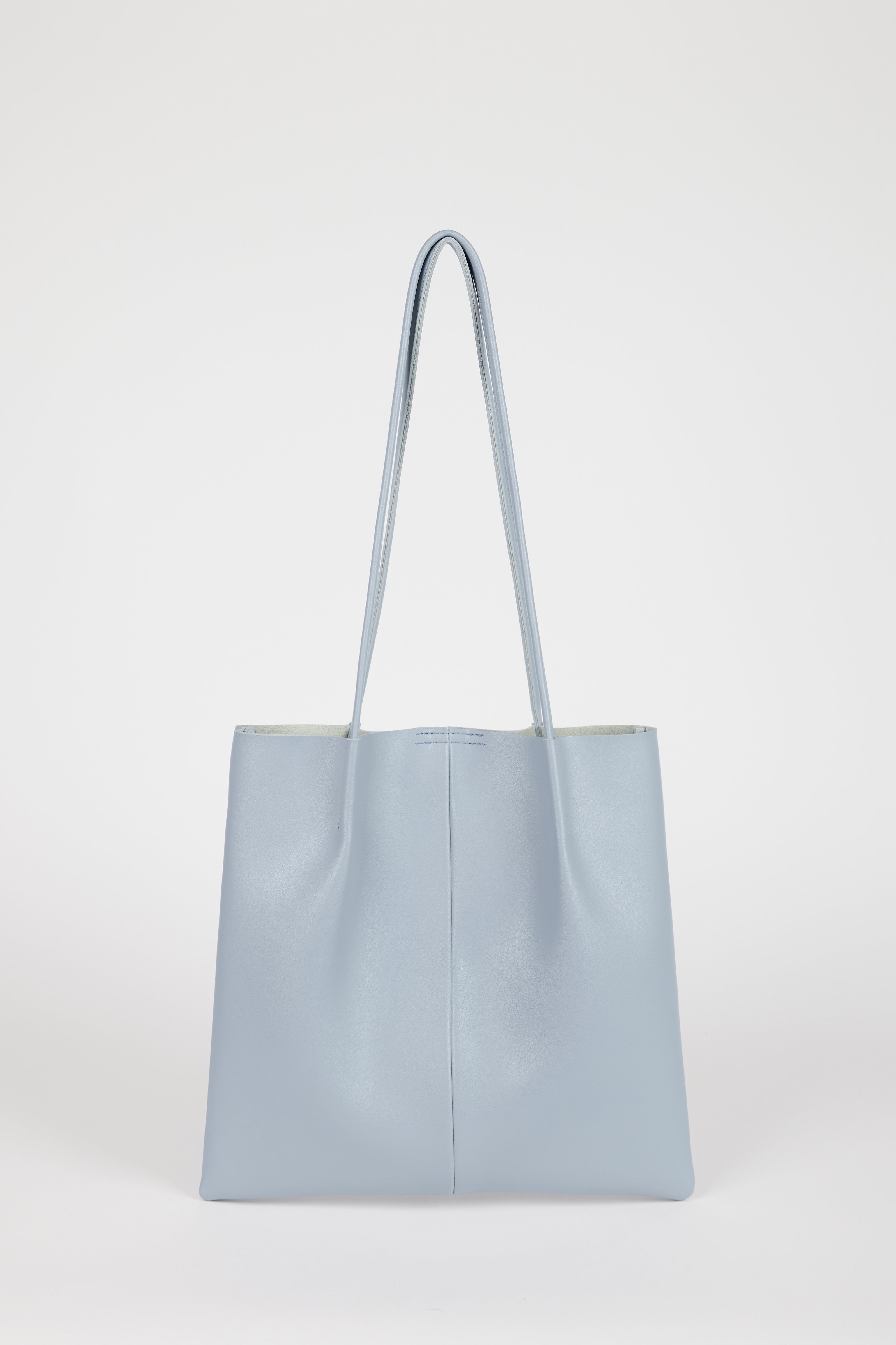Light blue vegan leather pinched strap tote bag