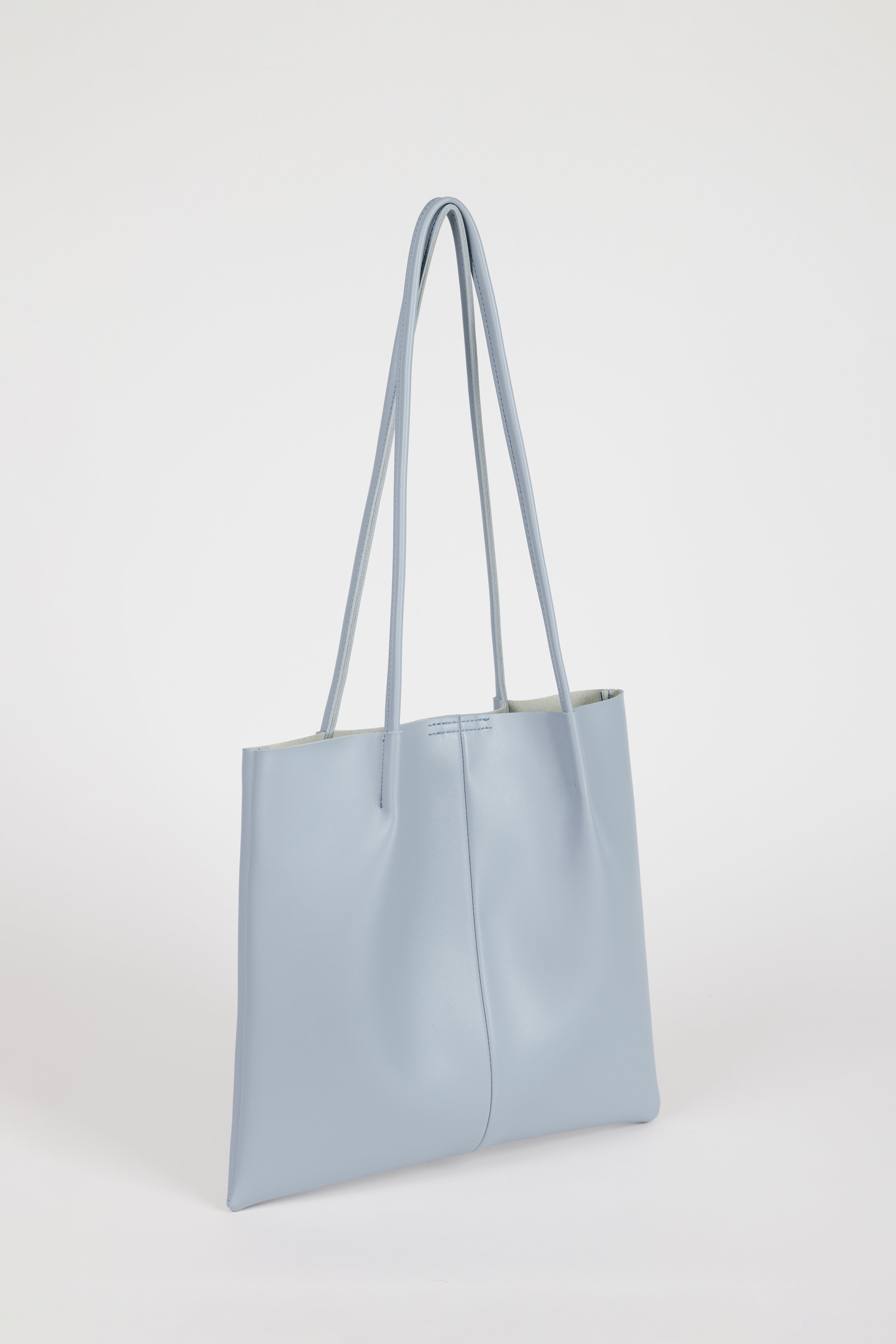 Light blue vegan leather pinched strap tote bag