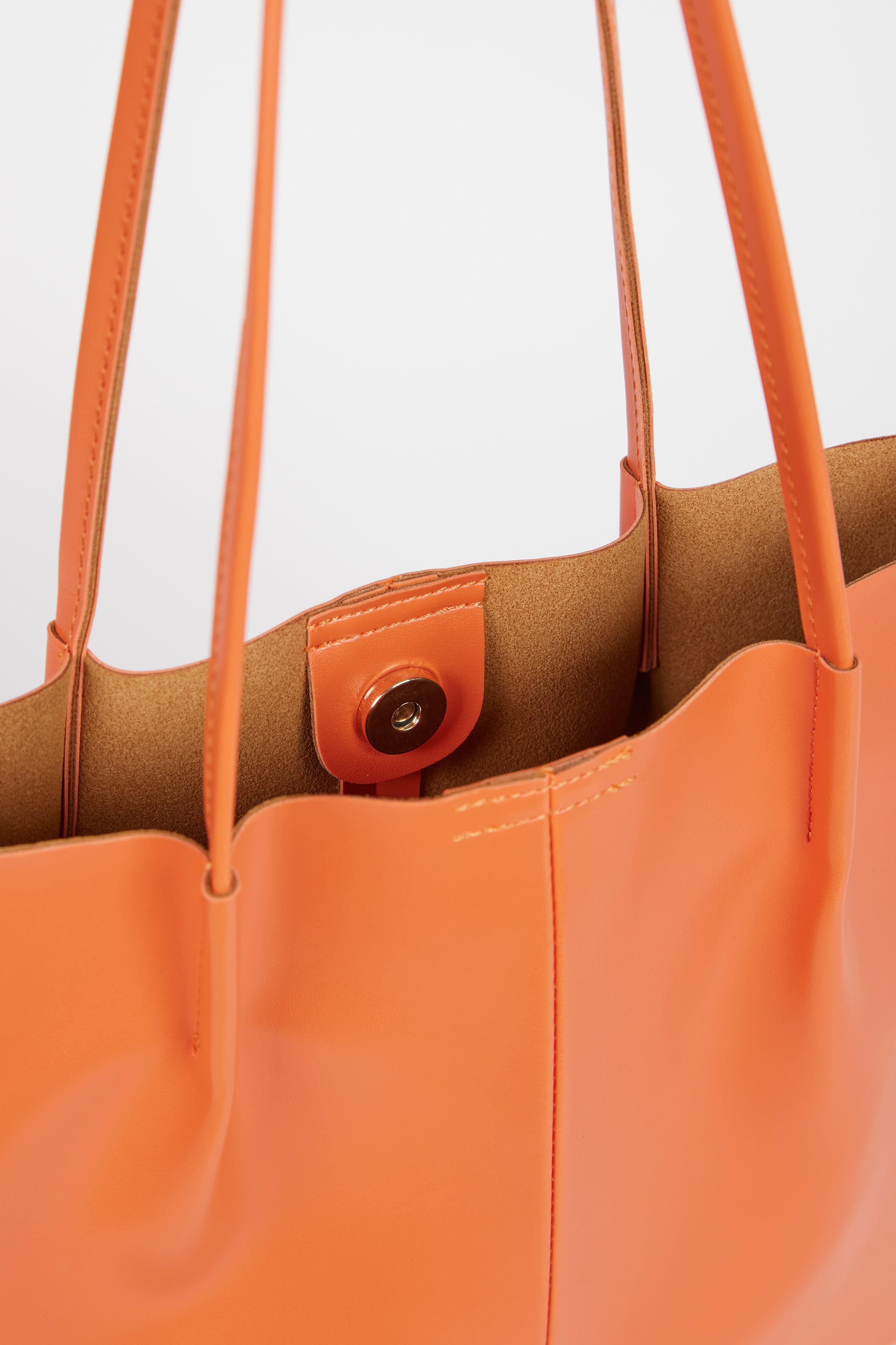 Orange vegan leather pinched strap tote bag